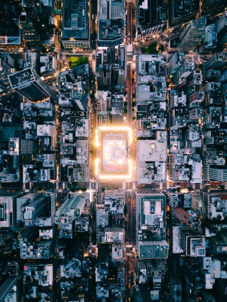 Aerial view of a brightly lit city at dusk.